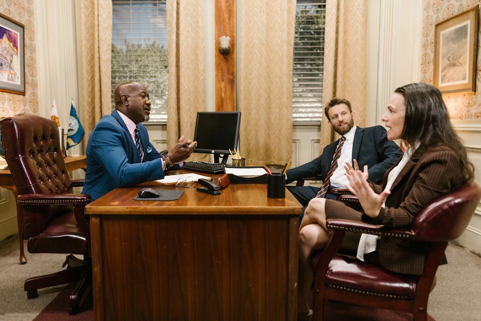 Attorney meeting with two clients in a law office