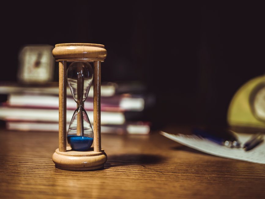 Hourglass on a wooden desk