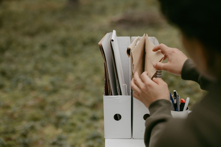 Person sorting papers into file holders