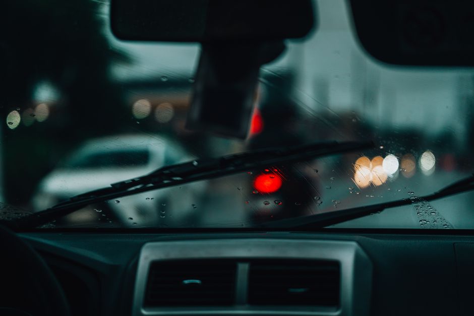 City lights through a rainy windshield at night