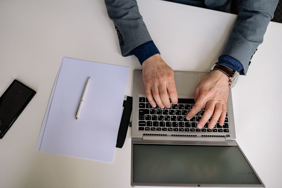 Attorney typing on a laptop at a desk