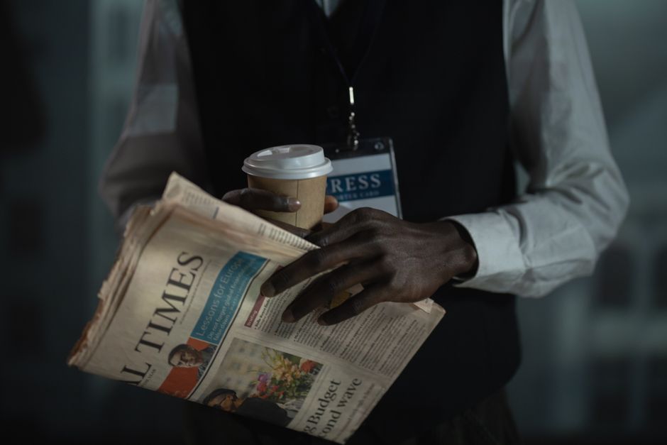 Journalist holding a newspaper