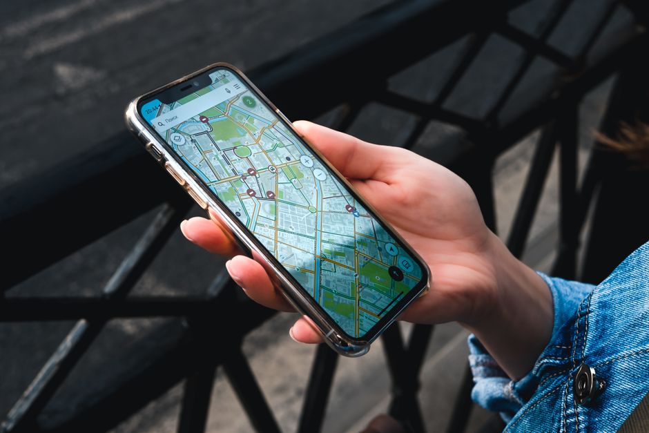 Hand holding a phone showing a map